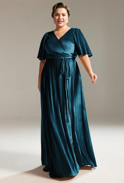 A plus size woman wearing a teal long dress shopping for a Stretto - Velvet Bridesmaid Dress Off The Rack at Bergamot Bridal in London.