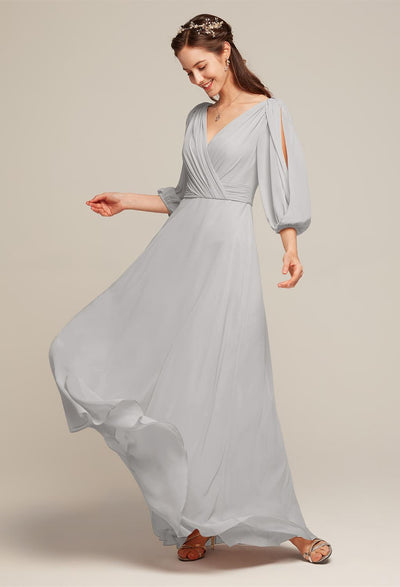 A bridesmaid in a grey long dress with a v-neck. The Polly - Chiffon Bridesmaid Dress - Off the Rack by Bergamot Bridal was bought at a bridal shop in London.