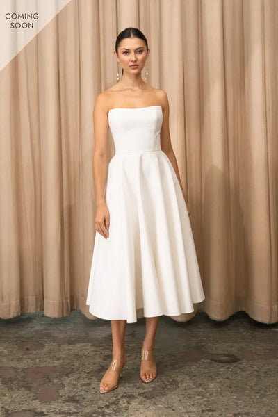 The model is wearing the Carrie - Jenny Yoo Little White Dress from Bergamot Bridal.
