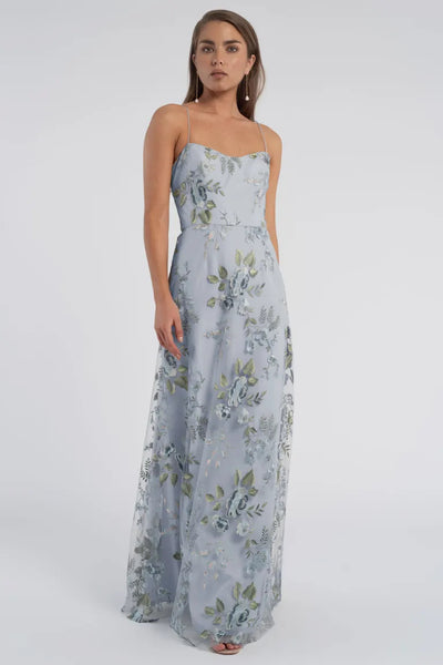 Woman wearing a light blue Drew - Jenny Yoo Bridesmaid Dress standing against a neutral background.