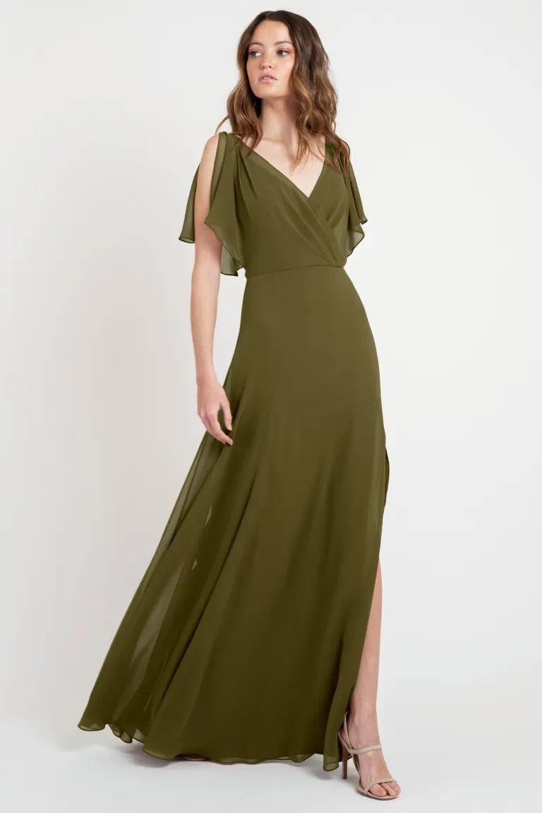 Woman in a beautiful, elegant olive green evening dress with flutter sleeves, sample size 24 - Hayes Bridesmaid Dress by Jenny Yoo from Bergamot Bridal.