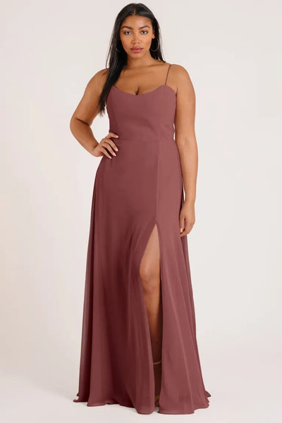 Woman posing in a luxe chiffon Kiara bridesmaid dress by Jenny Yoo with a side slit from Bergamot Bridal.