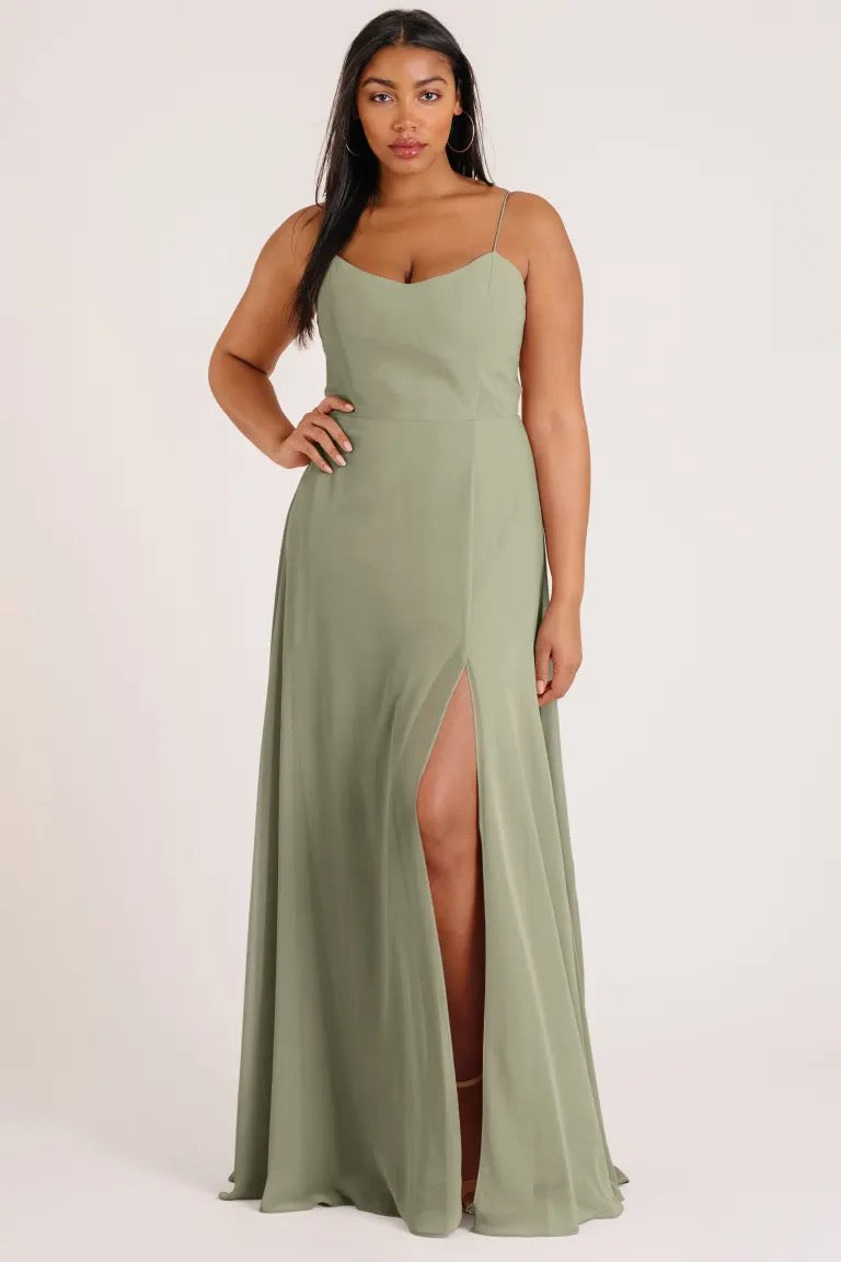 Woman in a luxe chiffon Kiara - Bridesmaid Dress by Jenny Yoo dress with a side slit from Bergamot Bridal.