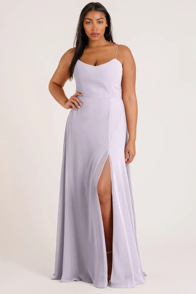 Woman in a light purple Kiara - Bridesmaid Dress by Jenny Yoo with a high slit and an A-line skirt from Bergamot Bridal.