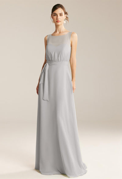 A woman in a long dress, searching for an Evita - Chiffon Bridesmaid Dress - Off The Rack from Bergamot Bridal.