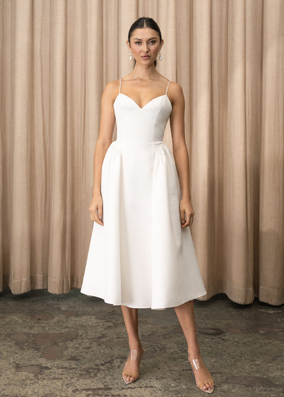 The model is wearing a Luella - Jenny Yoo Little White Dress by Bergamot Bridal.