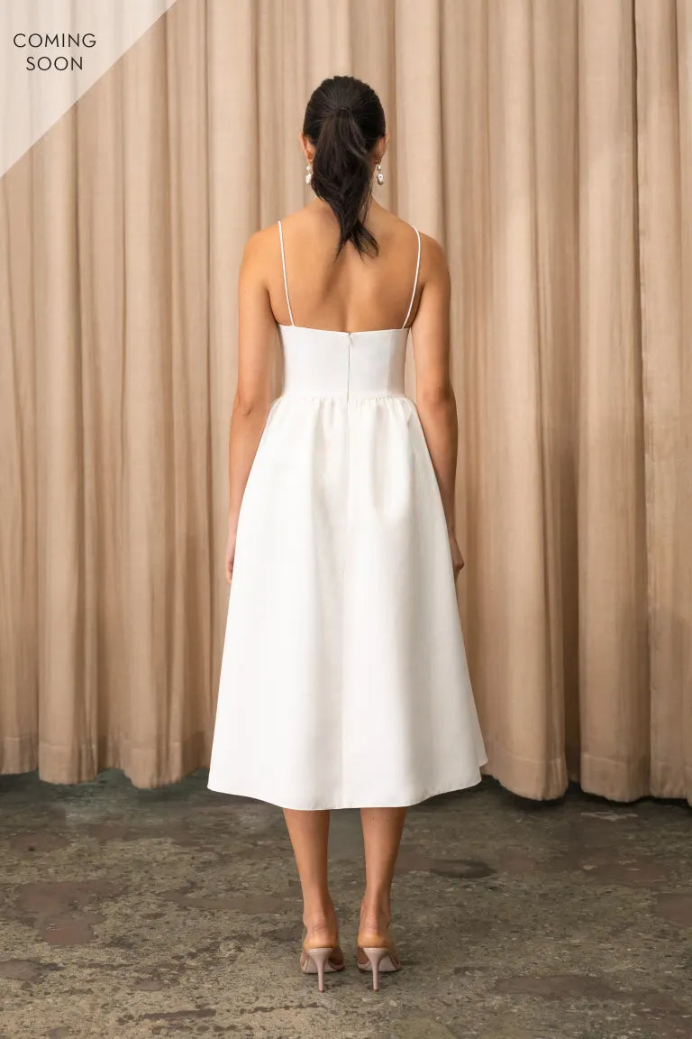 The back view of a woman wearing the Luella - Jenny Yoo Little White Dress at Bergamot Bridal in London.