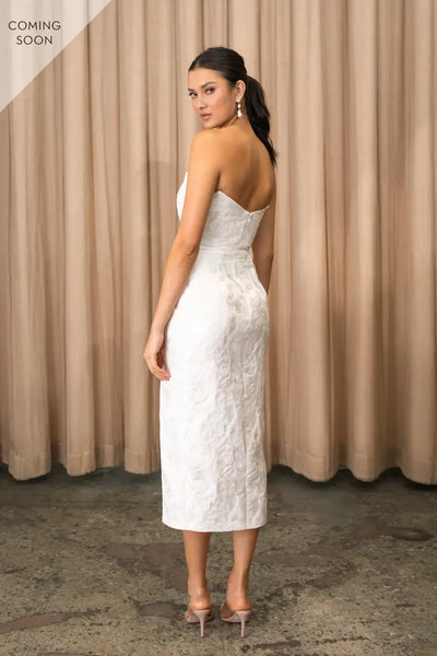 The back view of a woman wearing a white Marilyn - Jenny Yoo Little White Dress from Bergamot Bridal wedding dress.