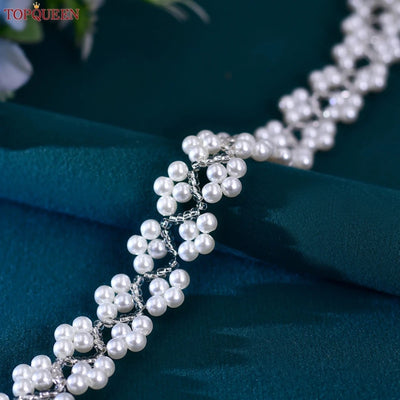 A close-up of the Pearl and Glass Beaded Bridal Belt by TopQueenOfficial on a dark green fabric background, displaying intricate beadwork and added detail perfect for a bride’s elegant belt.