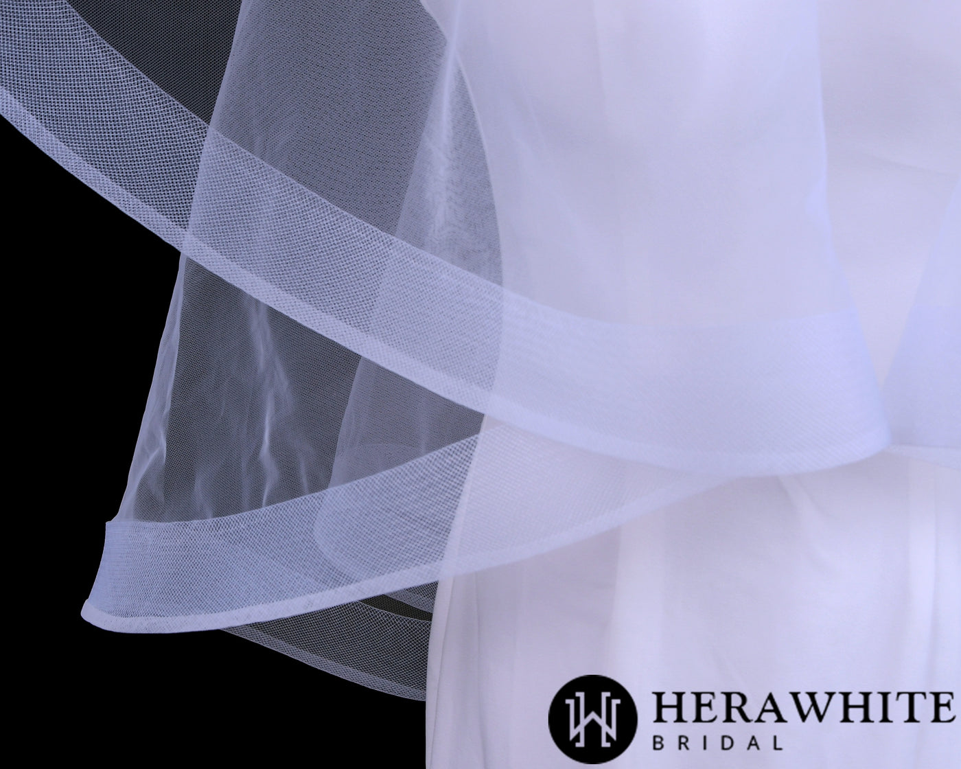 Close-up view of a white wedding dress with sheer fabric and a logo of Bergamot Bridal's White Horsehair Trim Bridal Veil in the corner.