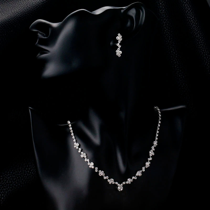 A black mannequin bust displaying a Bergamot Bridal Crystal Necklace and Earring Set, ideal for bridal shops, against a dark background.