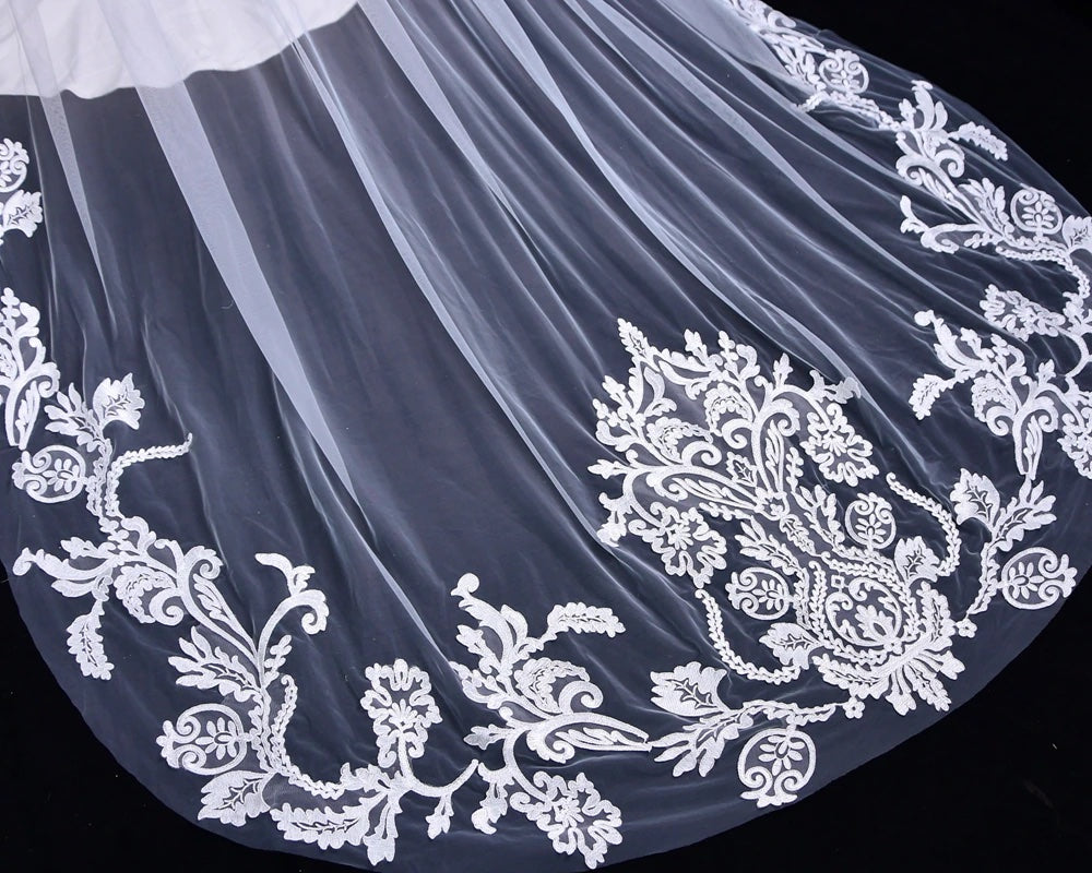 Elegant white Bergamot Bridal wedding veil with detailed lace embroidery on a black background, available at bridal shops in London, Ontario.