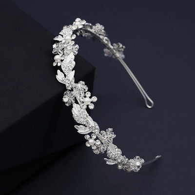 A Floral Crystal Bridal Hairband Wreath from Bergamot Bridal is displayed in a black box at bridal shops.