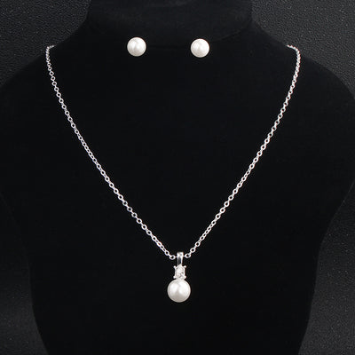 Elegant Bergamot Bridal pearl pendant necklace and stud earring set displayed on a black mannequin, perfect for bridal shops looking to showcase their collections.