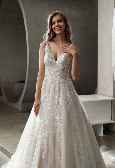 At the Bergamot Bridal shop in London, you can find a Stunning Tulle Lace Ball Gown with Glitter Tulle Underlay wedding dress with a v-neck and lace appliques.