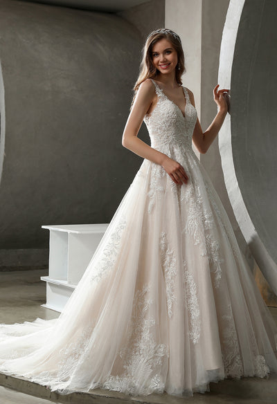 A Stunning Tulle Lace Ball Gown with Glitter Tulle Underlay by Bergamot Bridal, with a v-neck and lace appliques, can be found at a bridal shop.