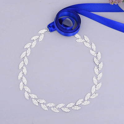 Silver vine leaf design necklace with a crystals ribbon on a gray background. 
Product: Bergamot Bridal's Silver leaf crystal bridal belt sash - Off The Rack