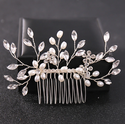 A Silver Crystal & Pearl Leaf Hair Comb adorned with pearls and leaves, perfect for Bergamot Bridal shops.