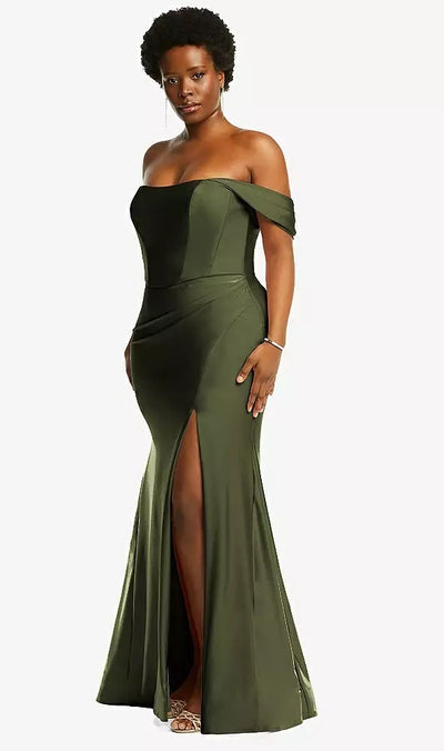 A woman wearing the Bergamot Bridal Off-the-Shoulder Corset Stretch Satin Mermaid Bridesmaid Dress, Style CS101 by Dessy, in olive green radiates elegance with its thigh-high slit and matching strap sandals. The gown's mermaid skirt gently accentuates her silhouette, creating a striking impression.