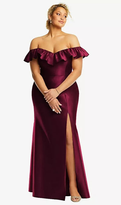 Wearing an Alfred Sung Style D836, Off-the-Shoulder Ruffle Neck Satin Trumpet Bridesmaid Gown in burgundy, from Bergamot Bridal, a person stands elegantly against a white background.