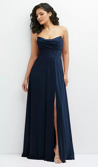 A woman in a strapless, navy blue Chiffon Corset Maxi Dress with Removable Off-the-Shoulder Swags Bridesmaid Dress - Style 1577 by Dessy from Bergamot Bridal poses against a plain white background, exuding a high-end aesthetic.