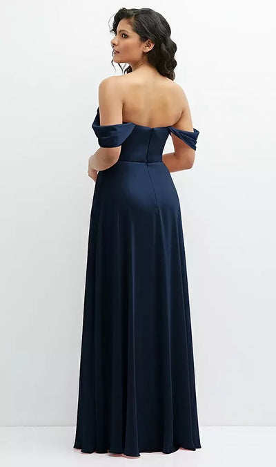 A woman in a Chiffon Corset Maxi Dress with Removable Off-the-Shoulder Swags Bridesmaid Dress (Style 1577 by Dessy), designed by Bergamot Bridal, stands against a plain white background, facing slightly away from the camera.