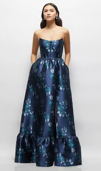 A woman stands against a plain background wearing the Bergamot Bridal Style 3152 gown, size 12, in Baroque Rose Damask—a strapless, floor-length dress with a fitted bodice, shirred skirt, and ruffled hem.