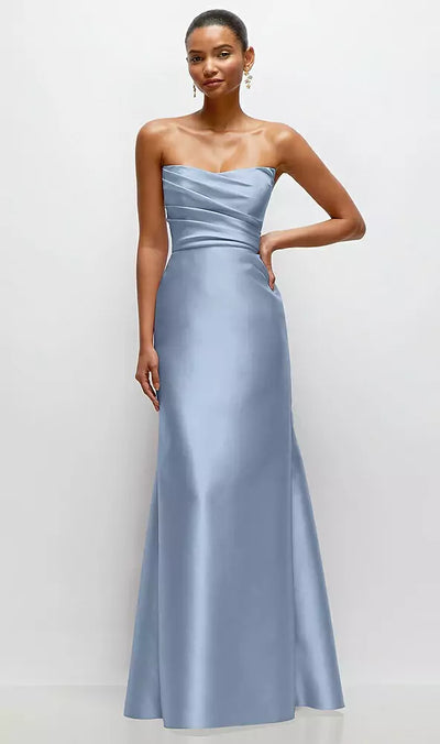 A woman poses against a plain background in the luxurious Strapless Cat-Eye Draped Bodice Satin Trumpet Bridesmaid Dress (Style D871) by Alfred Sung Bentley from Bergamot Bridal, her hand confidently resting on her hip.