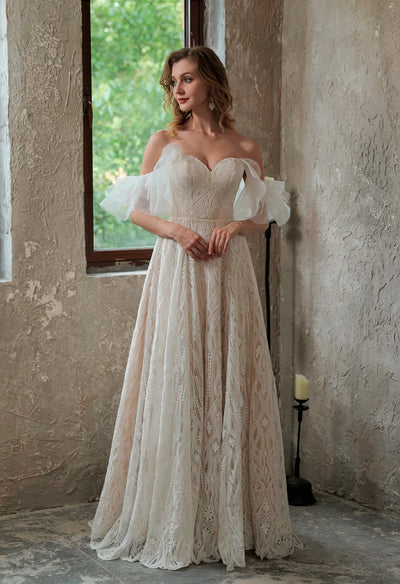An Allover Lace Boho Sweetheart Wedding Gown with Corset Back by Bergamot Bridal in a bridal shop in London.