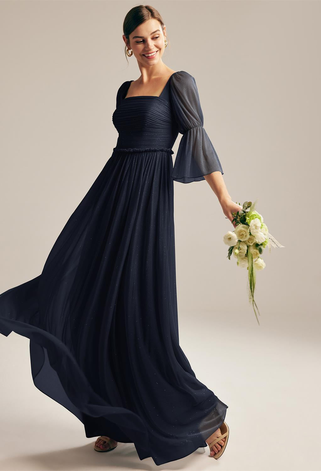 A bride in a navy blue Liza - Glitter Mesh Bridesmaid Dress - Off The Rack visited a bridal shop in London. The dress was from Bergamot Bridal.
