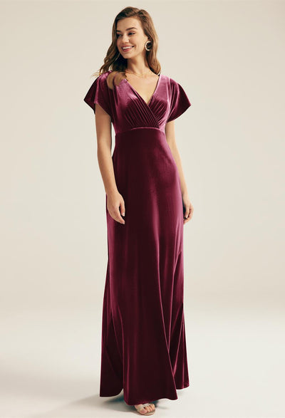 A woman wearing the Meara - Velvet Bridesmaid Dress - Off The Rack from Bergamot Bridal.