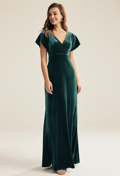 A woman wearing an Meara - Velvet Bridesmaid Dress - Off The Rack in London.