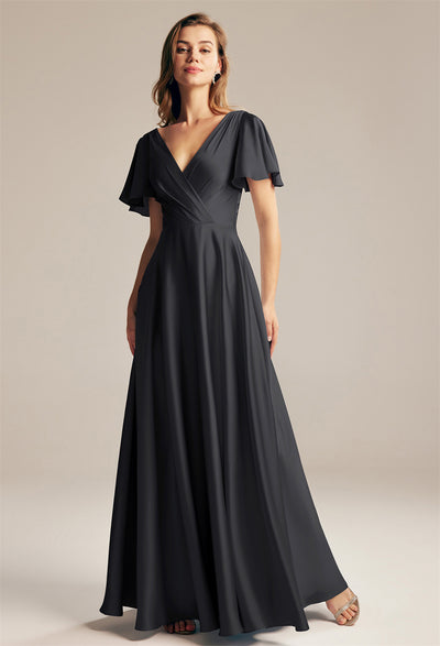 A woman wearing a black Furst - Satin Charmeuse Bridesmaid Dress - Off The Rack by Bergamot Bridal in London.