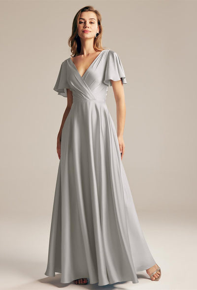 A woman wearing a Furst - Satin Charmeuse Bridesmaid Dress - Off The Rack by Bergamot Bridal in London.