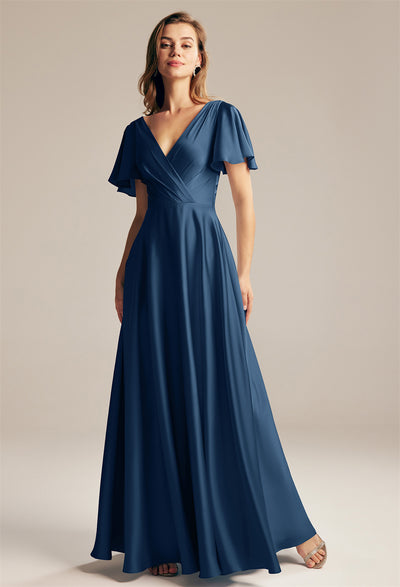 The bridesmaid is wearing a blue long Furst - Satin Charmeuse Bridesmaid Dress - Off The Rack by Bergamot Bridal.