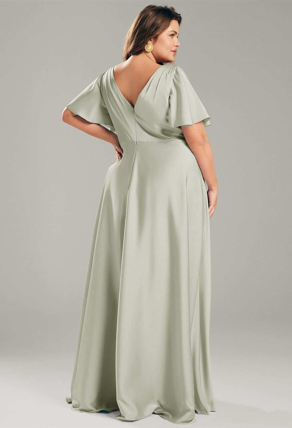 The back view of a Furst - Satin Charmeuse Bridesmaid Dress - Off The Rack in sage green available at Bergamot Bridal, a bridal shop in London.