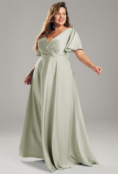 A plus size bridesmaid in a sage green Furst - Satin Charmeuse Bridesmaid Dress - Off The Rack gown shopping at a Bergamot Bridal bridal shop in London.