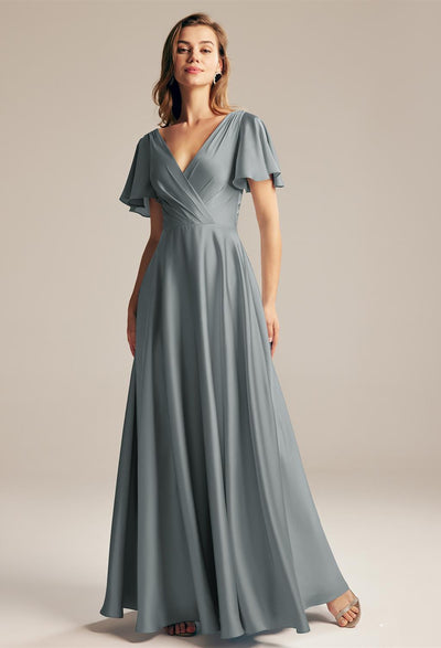 A woman wearing a grey Furst - Satin Charmeuse Bridesmaid Dress - Off The Rack by Bergamot Bridal in London.