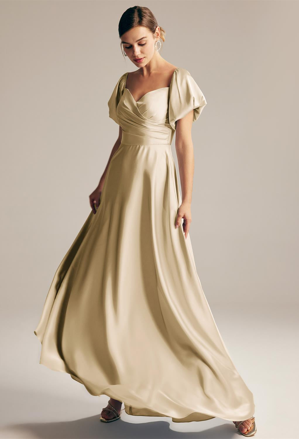 The bride is wearing a beige Dey - Satin Charmeuse Bridesmaid Dress - Off The Rack by Bergamot Bridal.