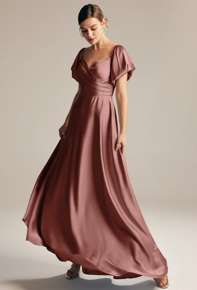 The Dey - Satin Charmeuse Bridesmaid Dress - Off The Rack by Bergamot Bridal in London is in a dark brown color and has a v-shaped neckline.