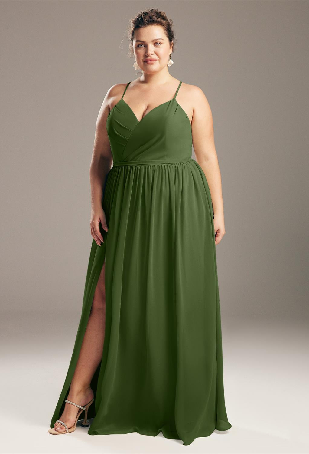 Woman in an elegant bridal gown posing with one hand on her hip, looking confident against a neutral background. 
Product Name: Bergamot Bridal - Wilfreda Chiffon Bridesmaid Dress - Off The Rack