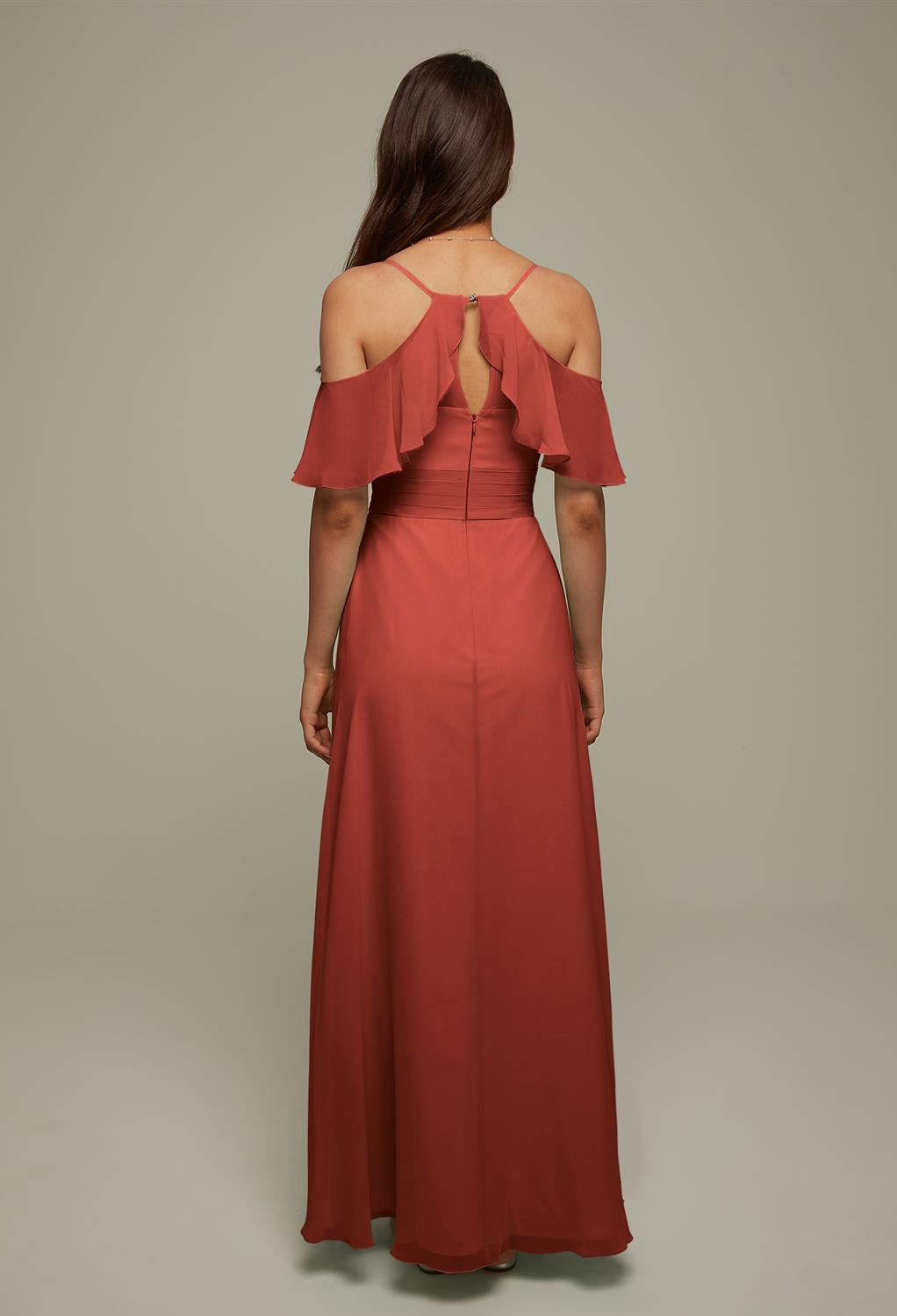 The back view of a woman in a Jenifer - Chiffon Bridesmaid Dress - Off the Rack with ruffles from Bergamot Bridal.