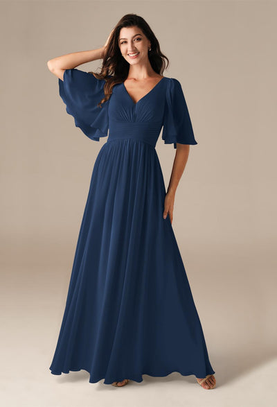 A woman wearing a Kenney - Chiffon Bridesmaid Dress - Off The Rack in London for Bergamot Bridal.