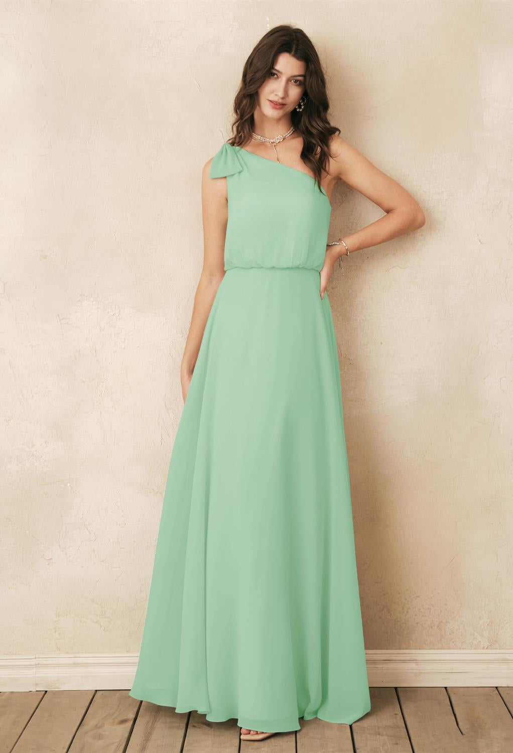 A woman wearing a mint green Robina - Chiffon Bridesmaid Dress - Off The Rack found at Bergamot Bridal in London.