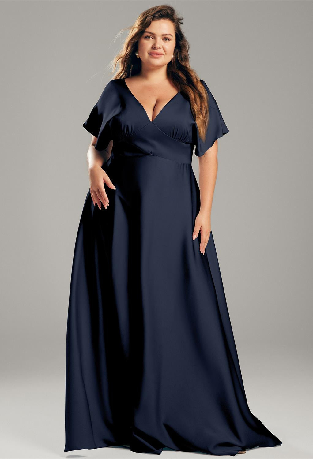 A plus size woman in the Nora - Satin Charmeuse Bridesmaid Dress - Off The Rack by Bergamot Bridal.