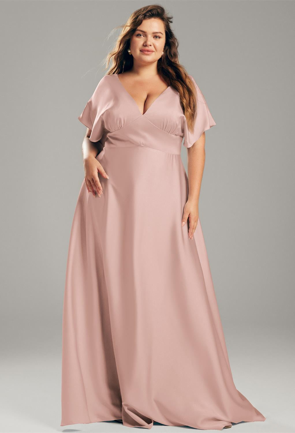 A Nora - Satin Charmeuse Bridesmaid Dress - Off The Rack in blush available at a Bergamot Bridal bridal shop in London.