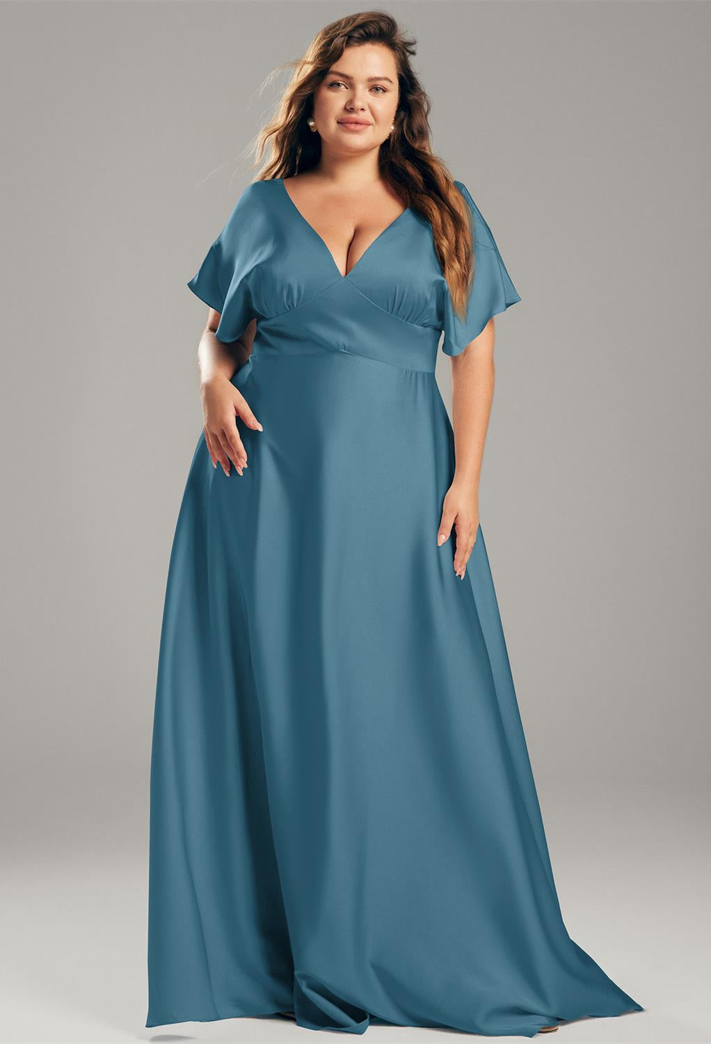 The Nora - Satin Charmeuse Bridesmaid Dress - Off The Rack by Bergamot Bridal in blue, plus size, with a v-neck can be found at bridal shops in London.