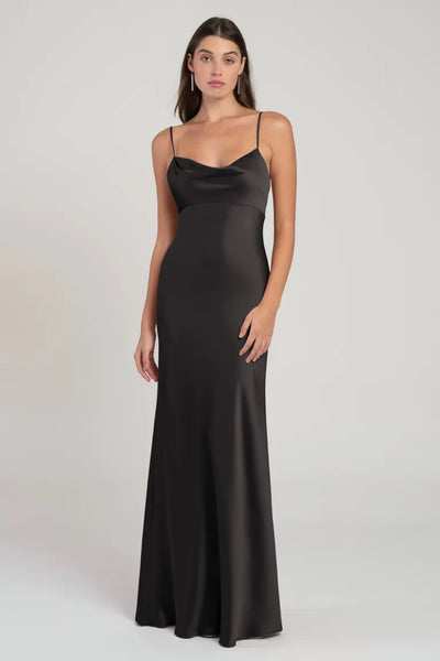 Woman posing in a sleek black satin slip evening gown, the Addison Bridesmaid Dress by Jenny Yoo at Bergamot Bridal.