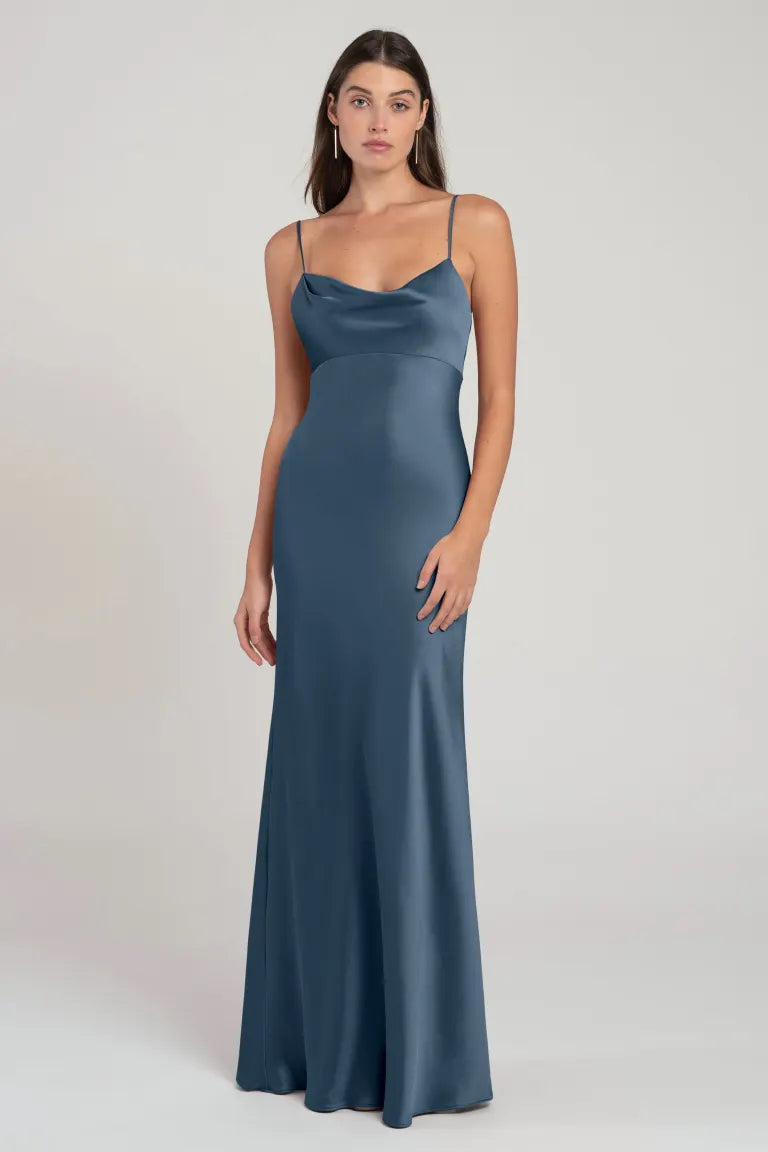 A woman in the Addison - Bridesmaid Dress by Jenny Yoo from Bergamot Bridal standing against a neutral background.