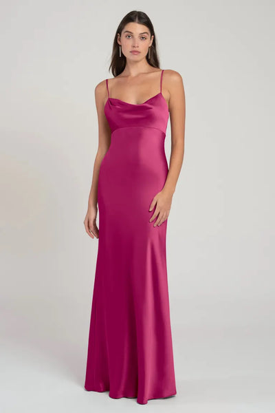 Woman posing in a long, satin slip dress with an empire waist, the Addison Bridesmaid Dress by Jenny Yoo from Bergamot Bridal.